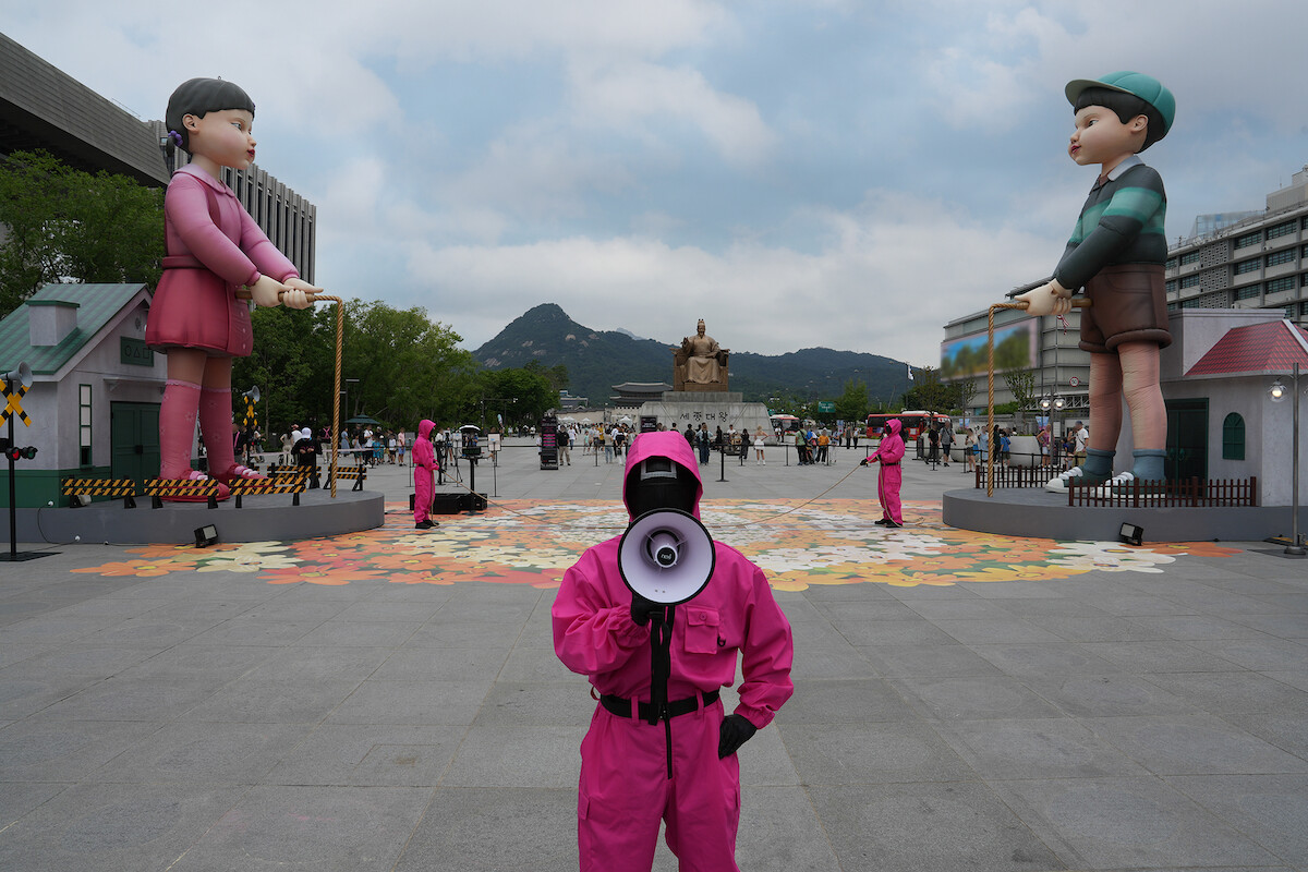 Pink Guard with a megaphone at the ‘Squid Game’ Season 3 Gwanghwamun event in Seoul.