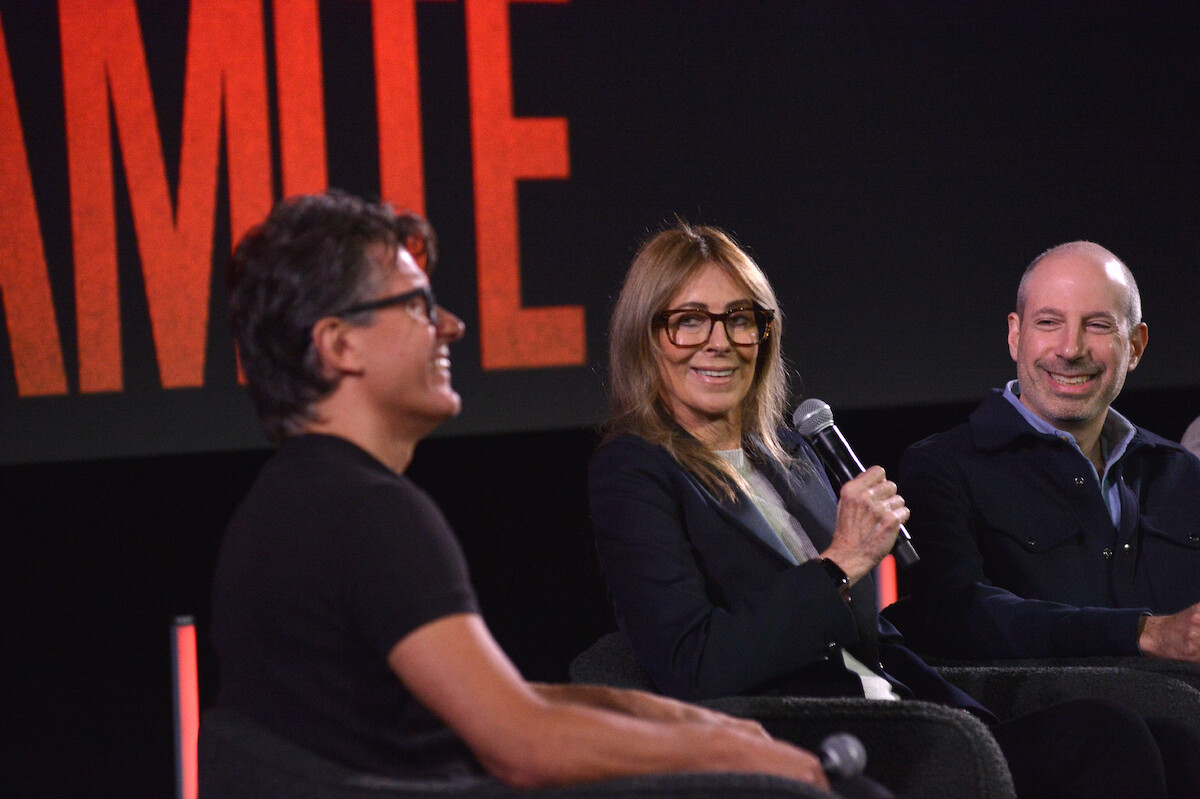 Anthony Breznican, Kathryn Bigelow, and Noah Oppenheim smile and sit on stage.