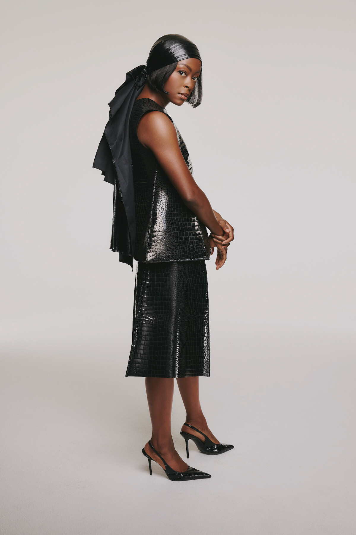 Danielle Deadwyler in a black ensemble against a white background.