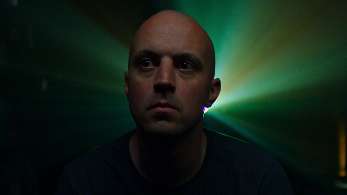 The light from a projector shines behind Connor Stalions.