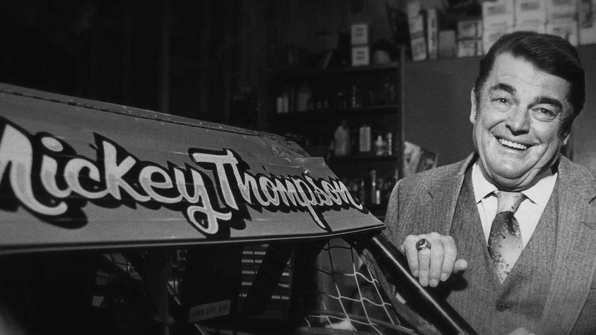 Mickey Thompson stands by his racecar.