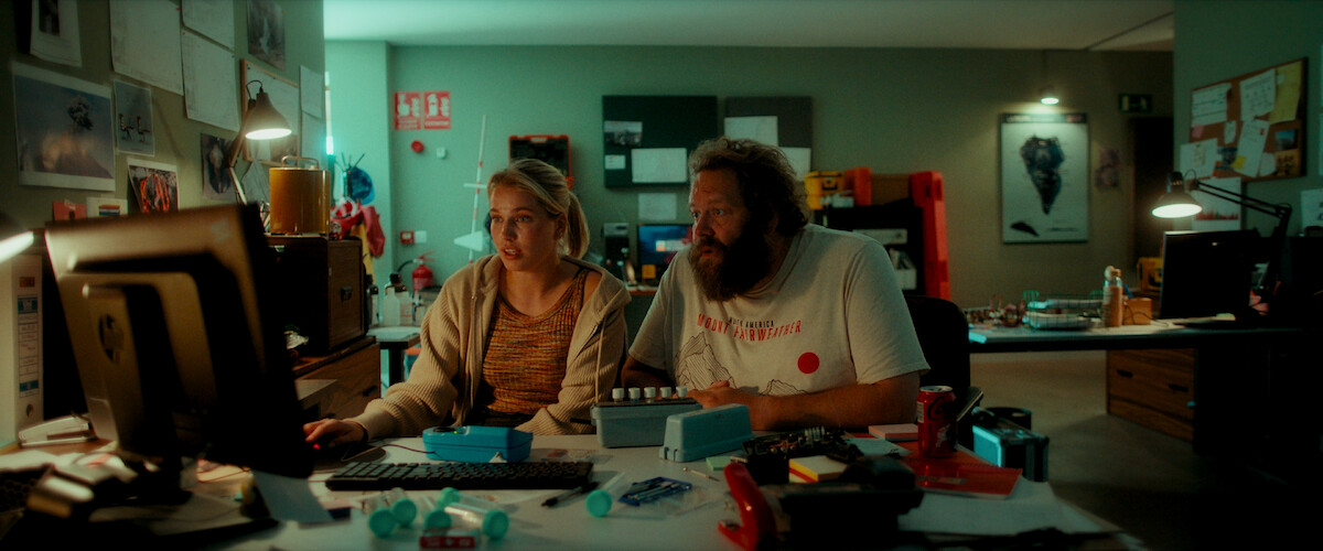 Thea Sofie Loch Næss as Marie Ekdal and Ólafur Darri Ólafsson as Haukur sit together by a computer in a dimly lit office in an image from the series ‘La Palma.’