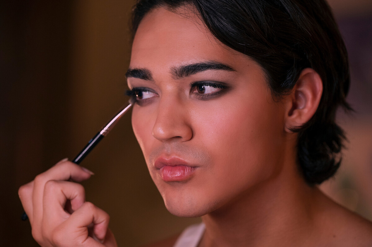 Miss Benny as Marco in ‘Glamorous’ Season 1 puts on makeup.