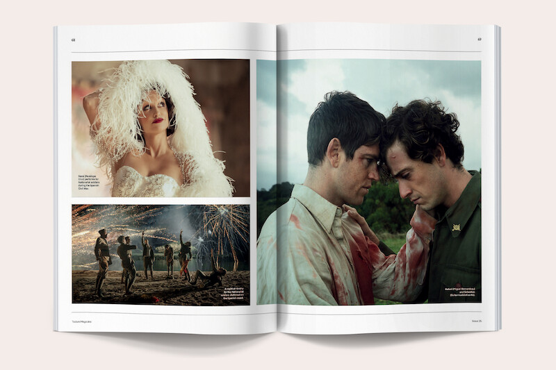 Open magazine spread showing three film scenes: a woman in a white feathered costume indoors, a group of dancers performing outside with fireworks in the background, and two men in bloodstained clothes in an emotional moment outdoors.