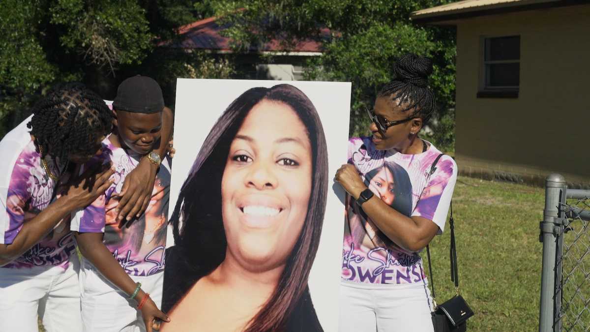 Community members of Ocala honor Ajike “AJ” Owens with a printed portrait and commemorative T-shirts.