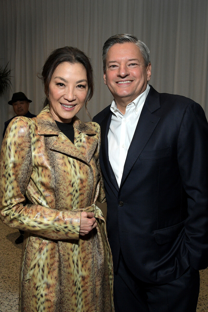 Michelle Yeoh and Ted Sarandos, Co-CEO of Netflix, smile at a party together at Netflix's 'The Brothers Sun' Los Angeles Premiere