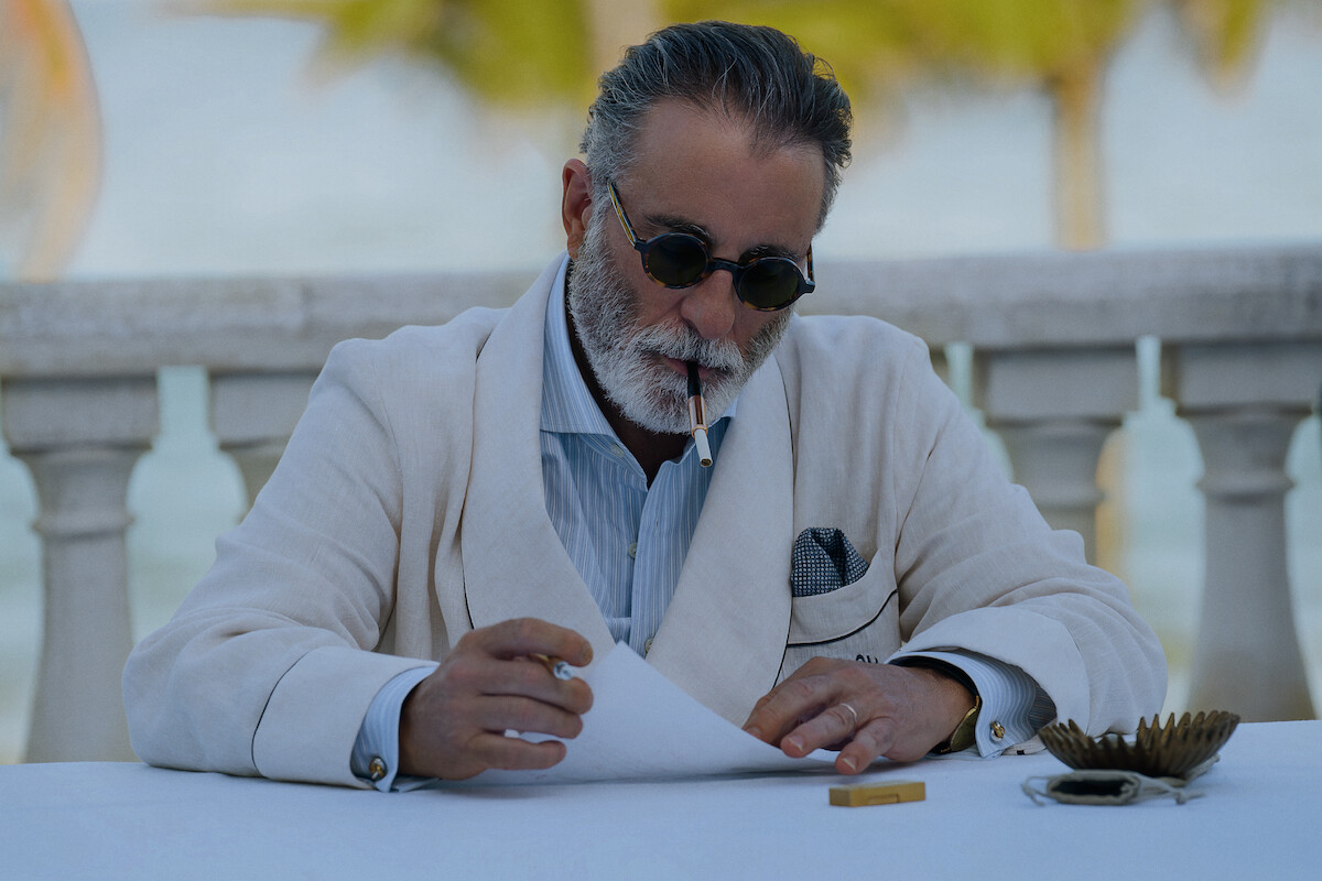 Andy Garcia sits at a table outside in ‘Pain Hustlers.’