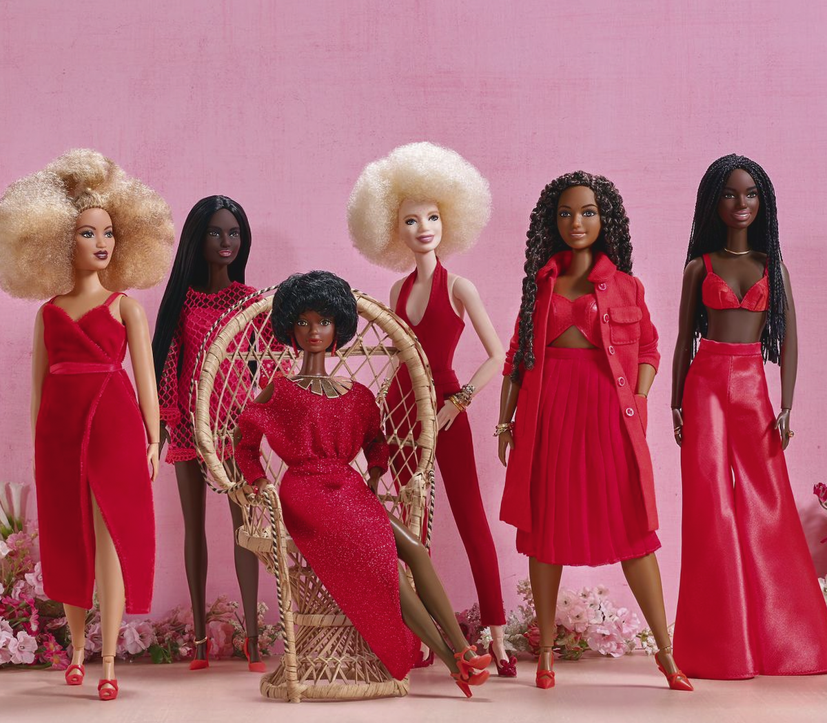 Several Barbie dolls posed together.