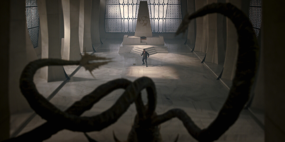 a person standing in a great hall.