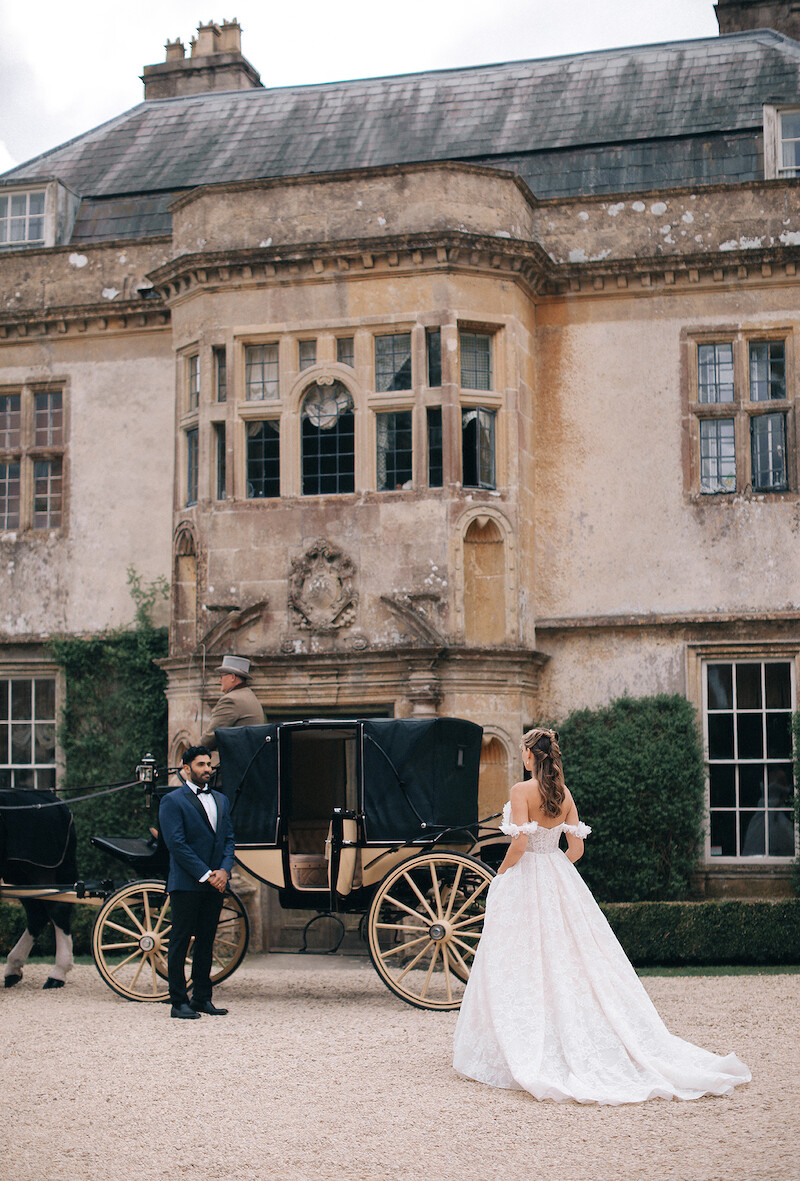 Woman in bridal dresses poses and looks off into the distance.