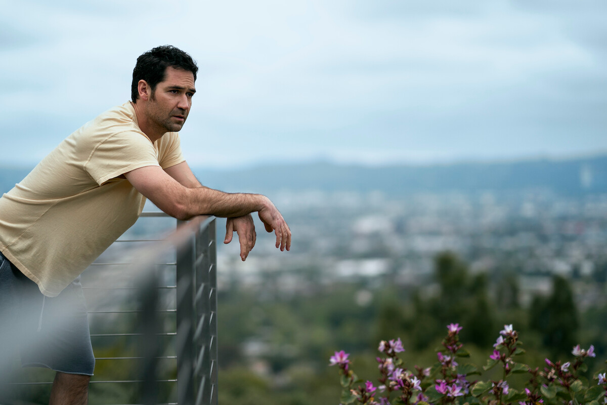 Mickey Haller looks out at Los Angeles from his balcony