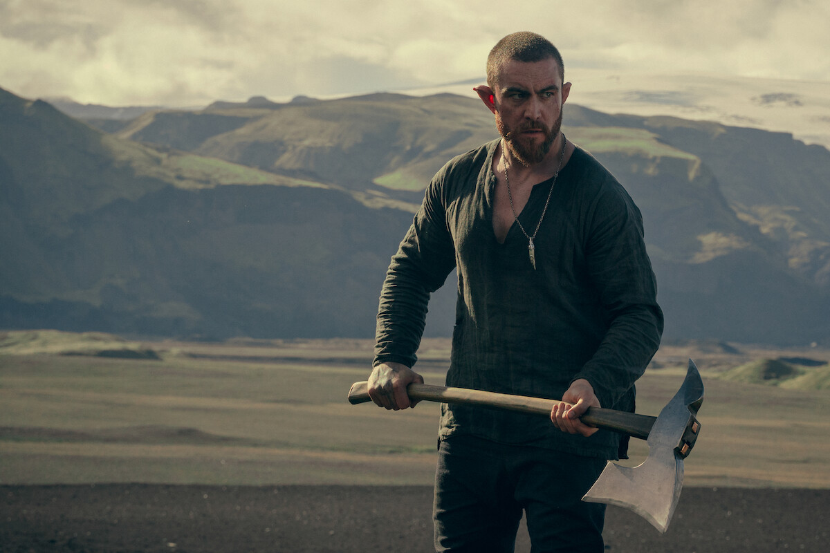 Fjall (Laurence O’Fuarain) holding an ax.