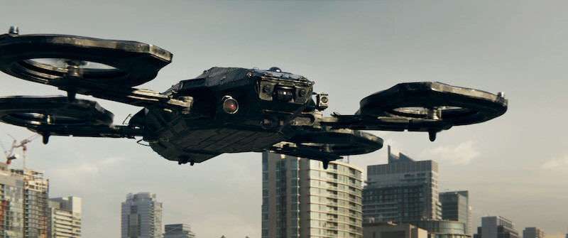 A futuristic aircraft hovers over a city in 'Code 8'