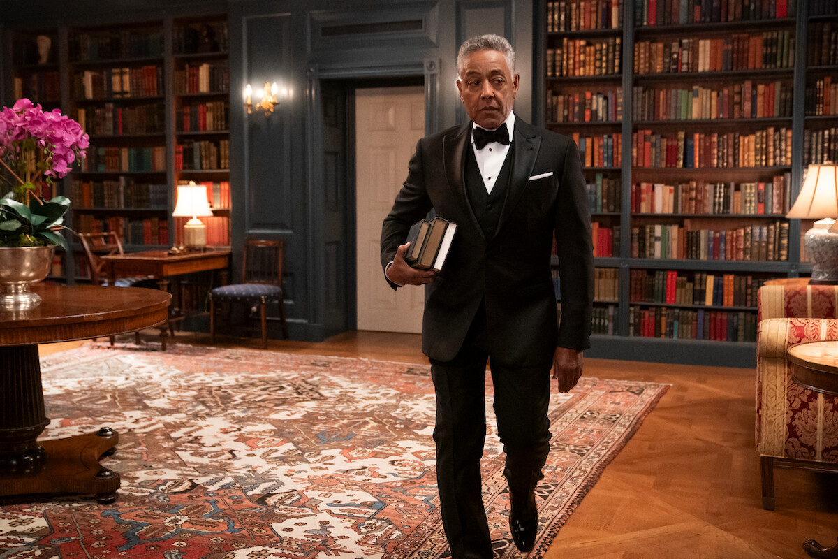 A.B. Wynter walking in the White House Library with books under his arm.