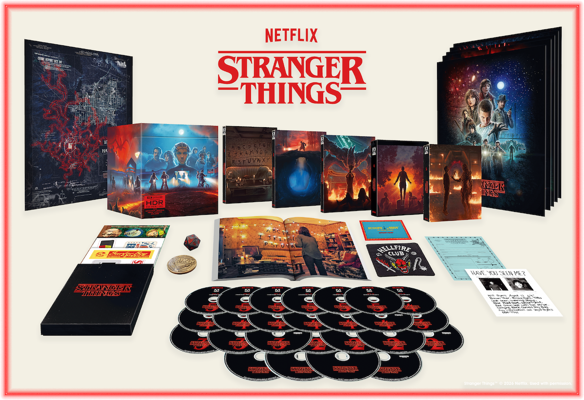 Stranger Things collector's box set with DVDs, character artwork, maps, cards, posters, and memorabilia arranged on a white surface, featuring promotional images and themed packaging.