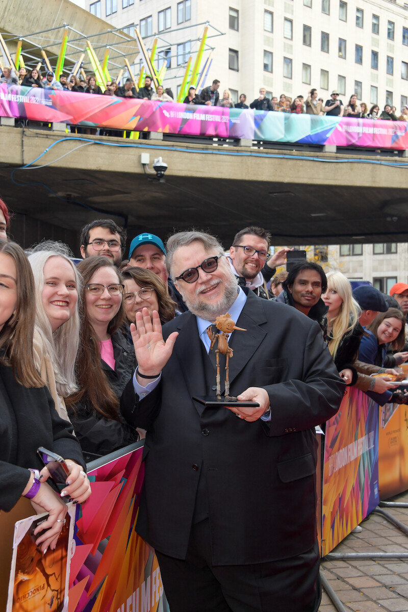 Director Guillermo del Toro poses with fans and model Pinocchio.- ‘Guillermo del Toro’s Pinocchio’ Cast at the London Film Festival
