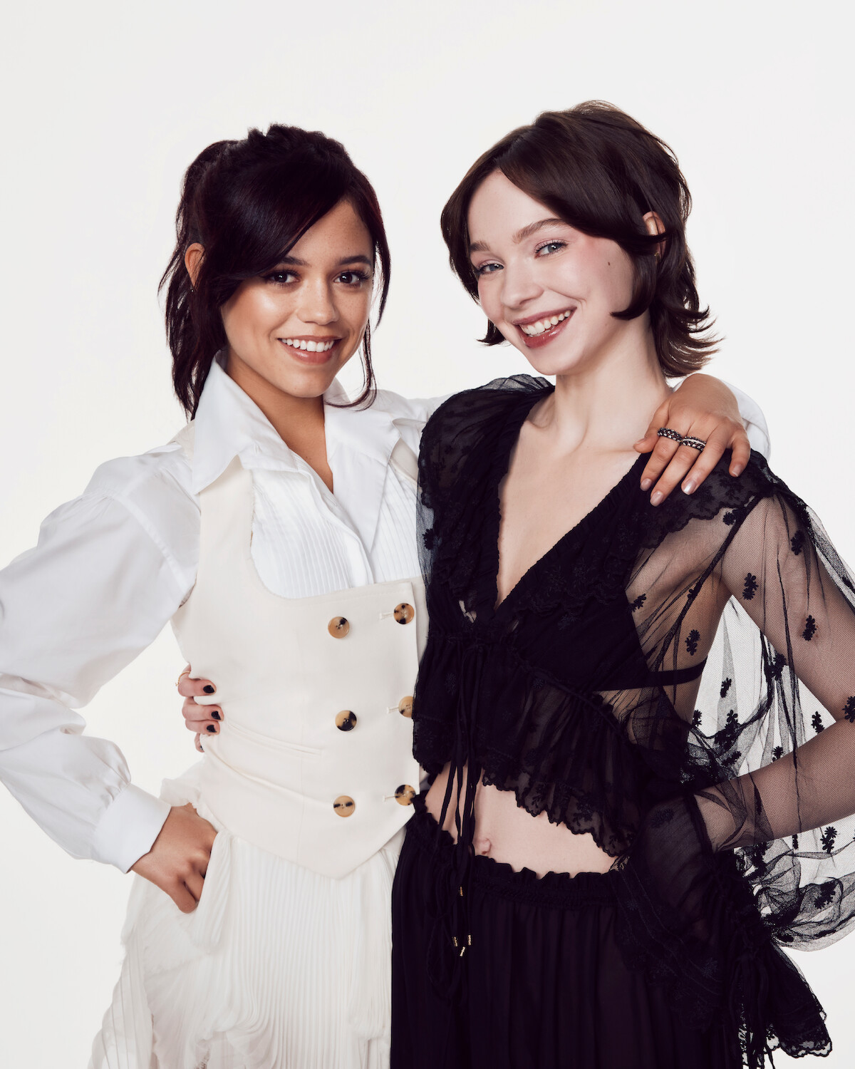 Jenna Ortega and Emma Myers smile together.