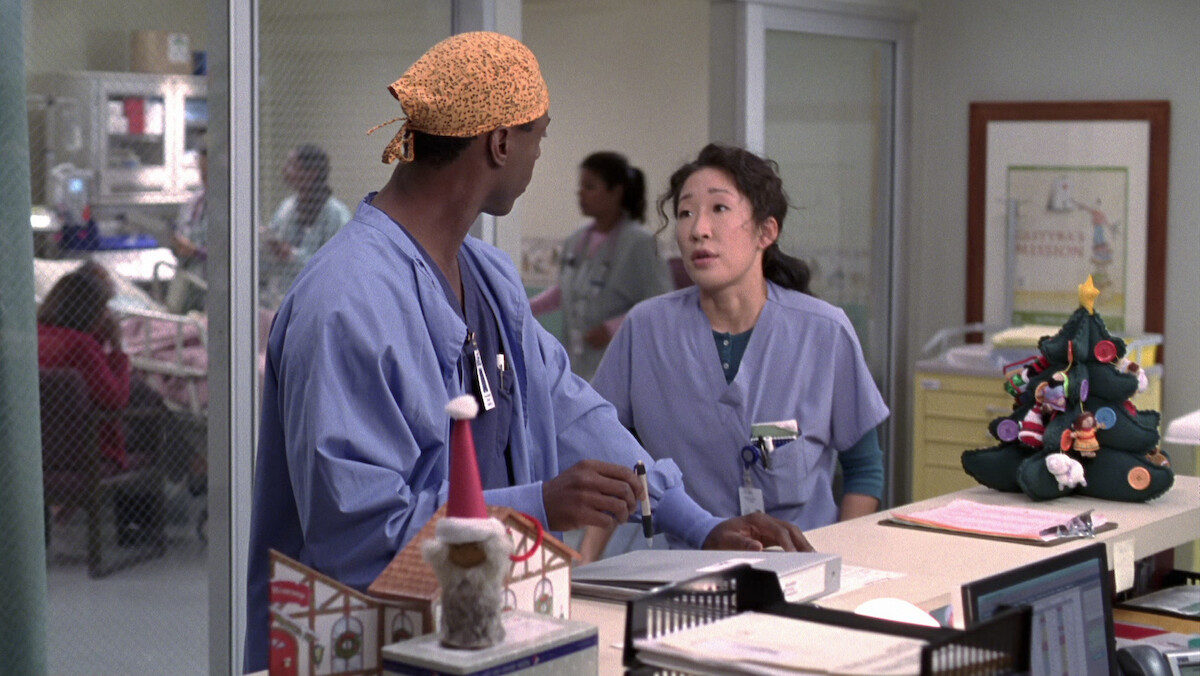 two doctors have a conversation among christmas decorations in the hospital.