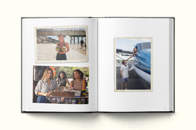 Photo album open to four young women: one holding a coconut on a beach, two at an indoor market, one posing with a plane on an airport tarmac. Each scene captures diverse travel settings and relaxed, happy moments.