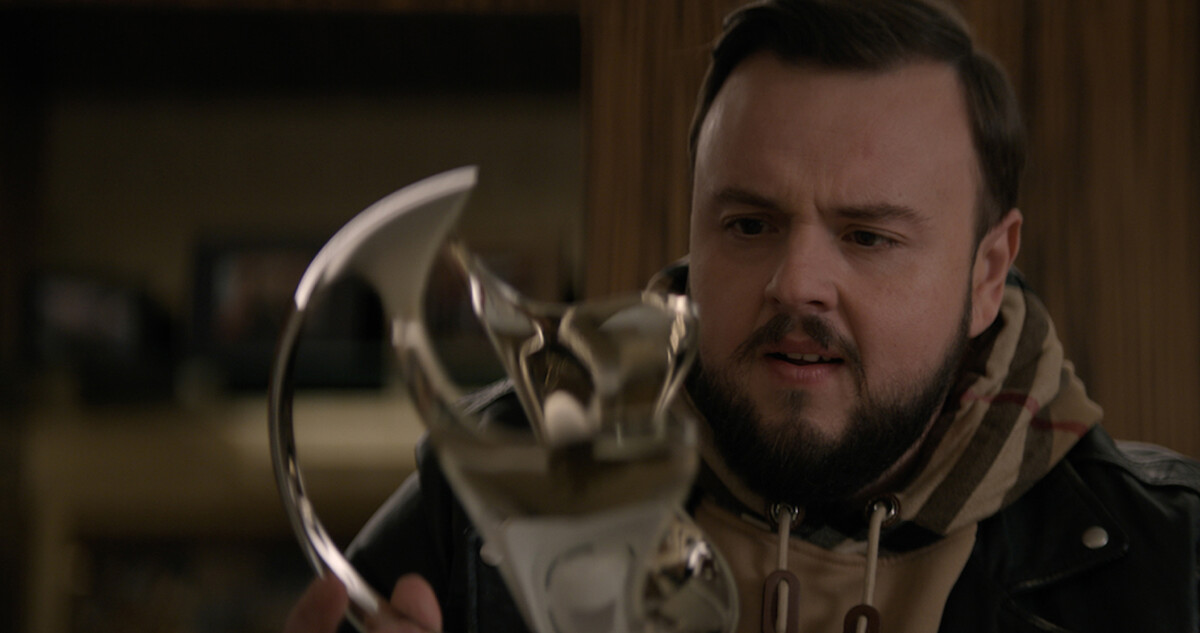 John Bradley as Jack Rooney holds up the VR headset in '3 Body Problem.'
