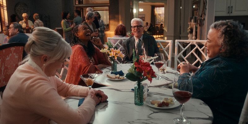 Veronica Cartwright as Beverly, Margaret Avery as Florence, Ted Danson as Charles, and Juana Samayoa as Peggy smile at a dinner table together in Season 1 of 'A Man on the Inside'