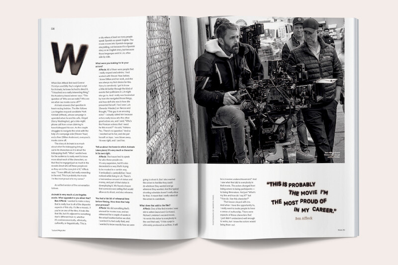 Two men on a film set operate a professional camera near a fence, one seated and the other standing, with crew members and equipment visible in a busy outdoor production environment. Magazine spread includes text and a large quote.
