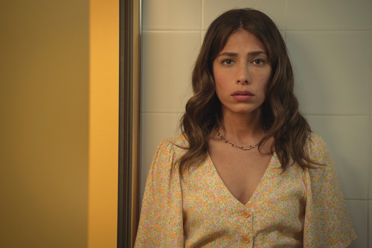 Evin Ahmad as Erin Carter stands with her back against a wall in ‘Who is Erin Carter?’
