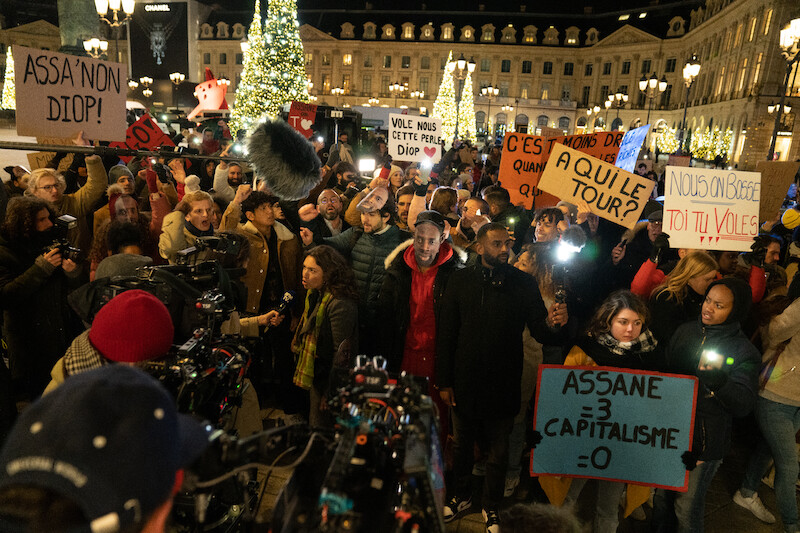 A crowd gathers in Paris in Season 3 of 'Lupin.'