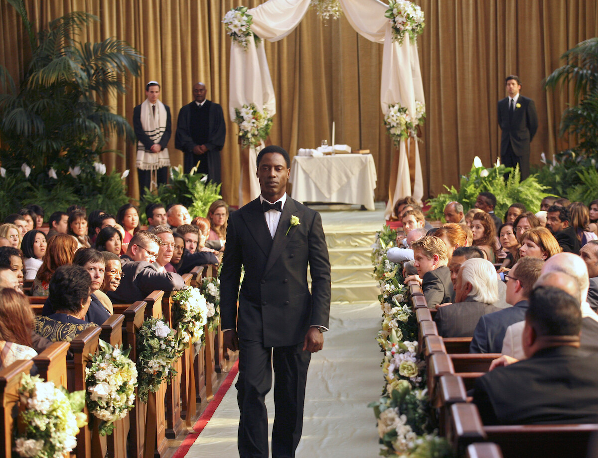 A groom walks down the aisle, without his bride.