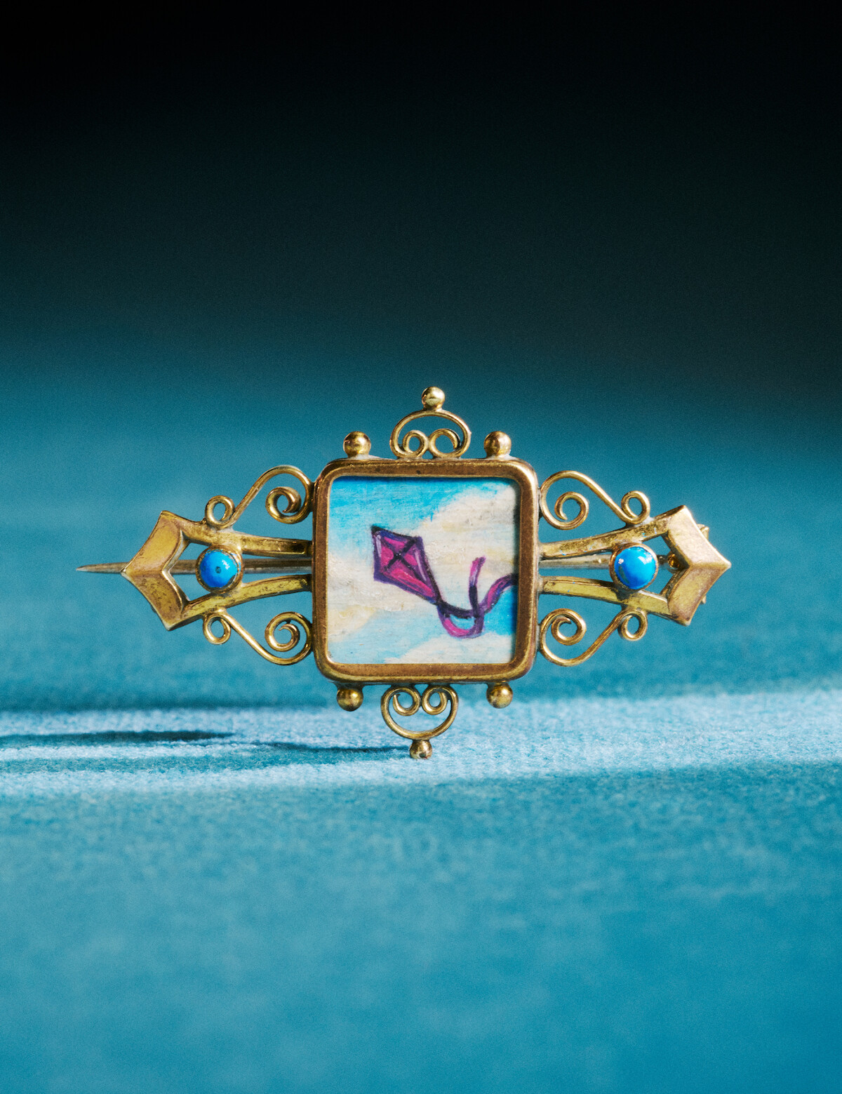 Benedict’s wedding brooch with a kite painted on it