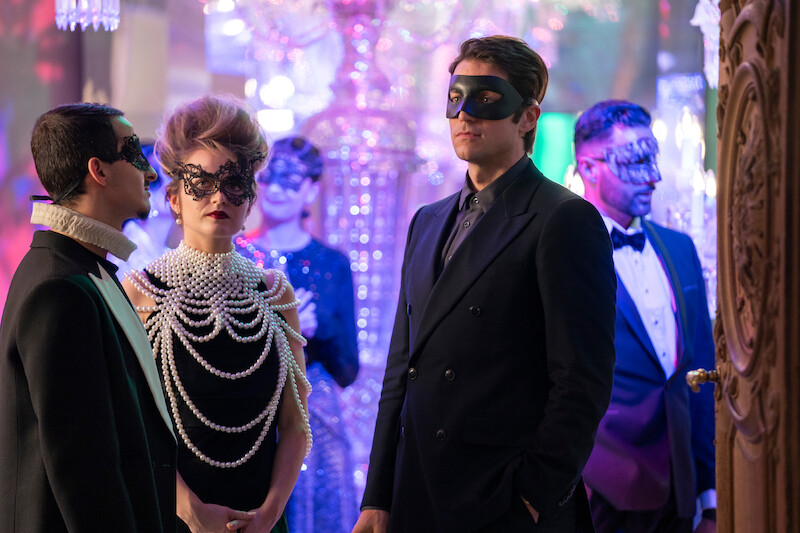 Lucas Bravo as Gabriel wears a masquerade mask at a party in Season 4 of 'Emily in Paris'