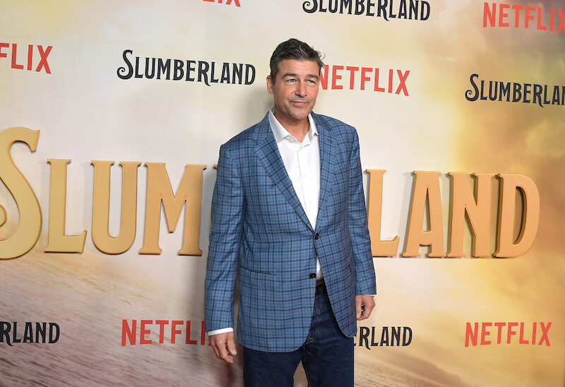 Kyle Chandler trades his cozy dad sweaters from the film for a dapper blue suit.