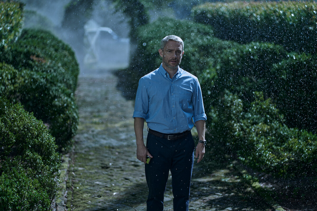 Martin Freeman as Jonathan Miller stands in a garden in ‘Miller’s Girl.’