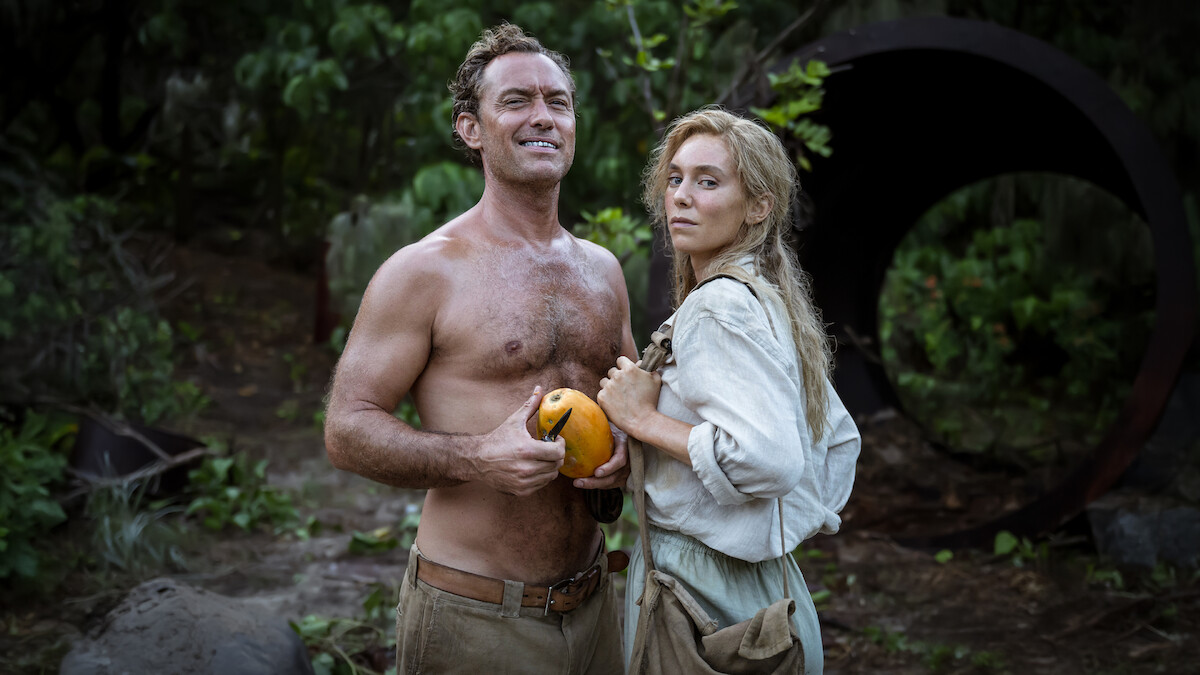 Jude Law as Friedrich and Vanessa Kirby as Dore cut some fruit in ‘Eden.’