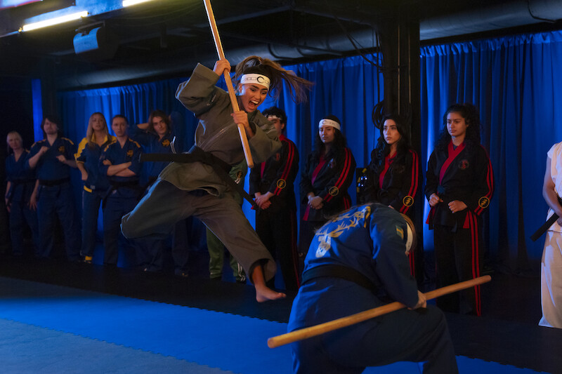 Rayna Vallandingham as Zara leaps in the air to attack an opponent in Season 6, Part 2 of 'Cobra Kai'