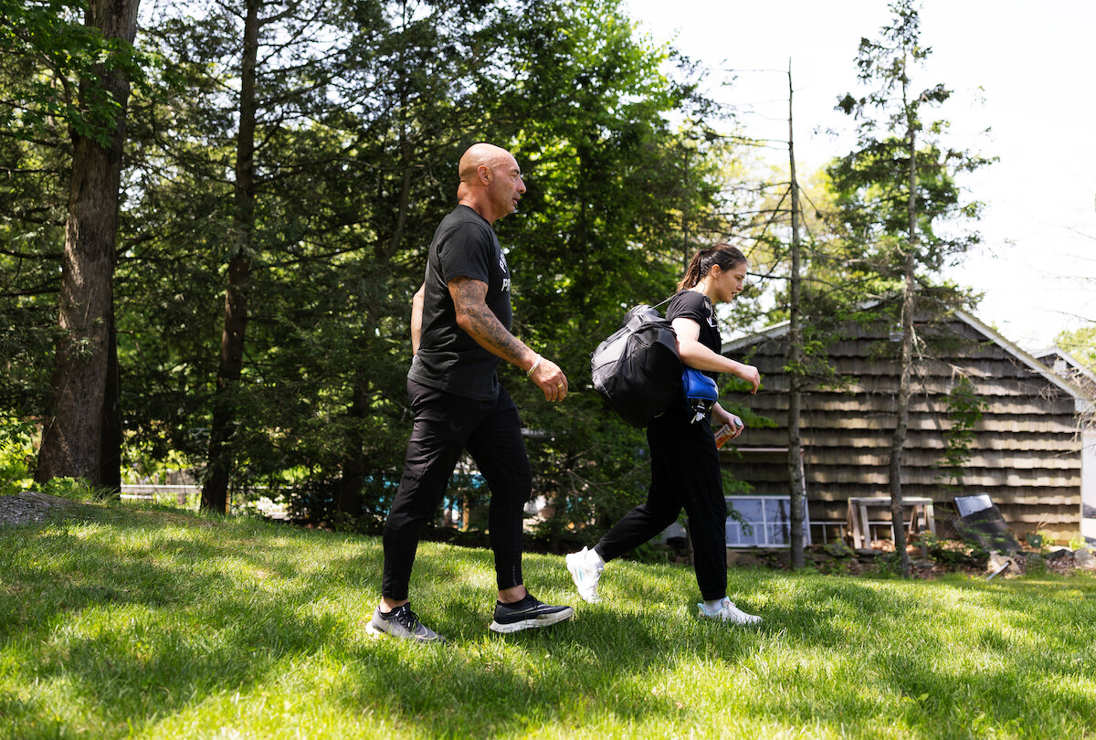 Katie Taylor walks outside with her trainer.