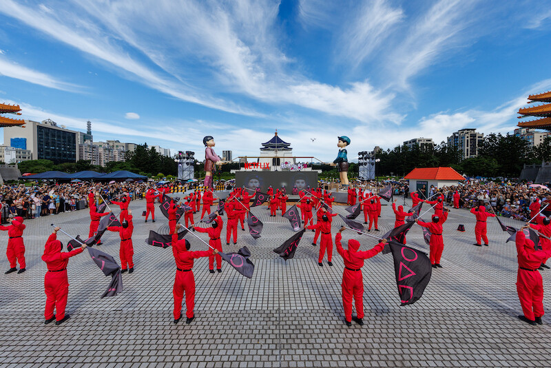 Pink Guards wave flags at a 'Squid Game' Season 3 event in Taipei.