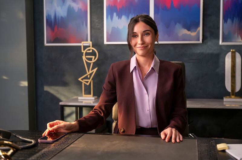Lilah Richcreek Estrada as Julie sits at a desk in Season 1 of 'A Man on the Inside'