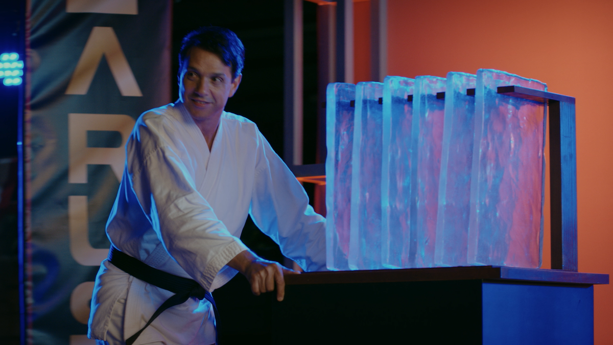Daniel in karate uniform wheels out a block of ice, similar to the one he broke apart in Karate Kid Part II.