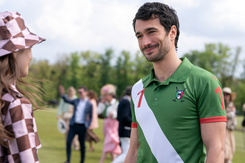 Eugenio Franceschini as Marcello smiles on a field in Season 4 of 'Emily in Paris'