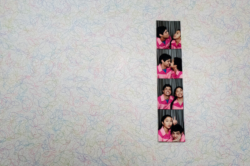 A photo booth film strip of Noah Centineo as Peter and Lana Condor as Lara Jean at the bowling alley.