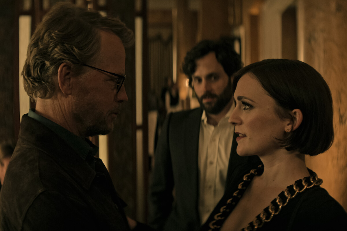 Greg Kinnear asTom Lockwood reunites with Charlotte Ritchie's Kate as Penn Badgley's Joe Goldberg watches on. 
