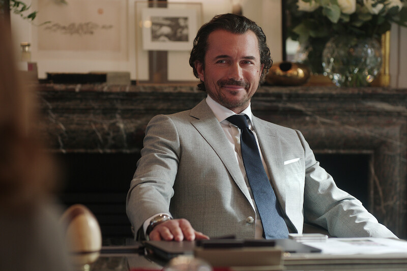 William Abadie as Antoine Lambert sits in an office in Season 4 of 'Emily in Paris'