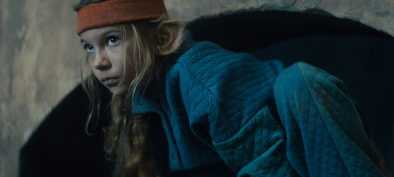 A hybrid child in a dark space. 