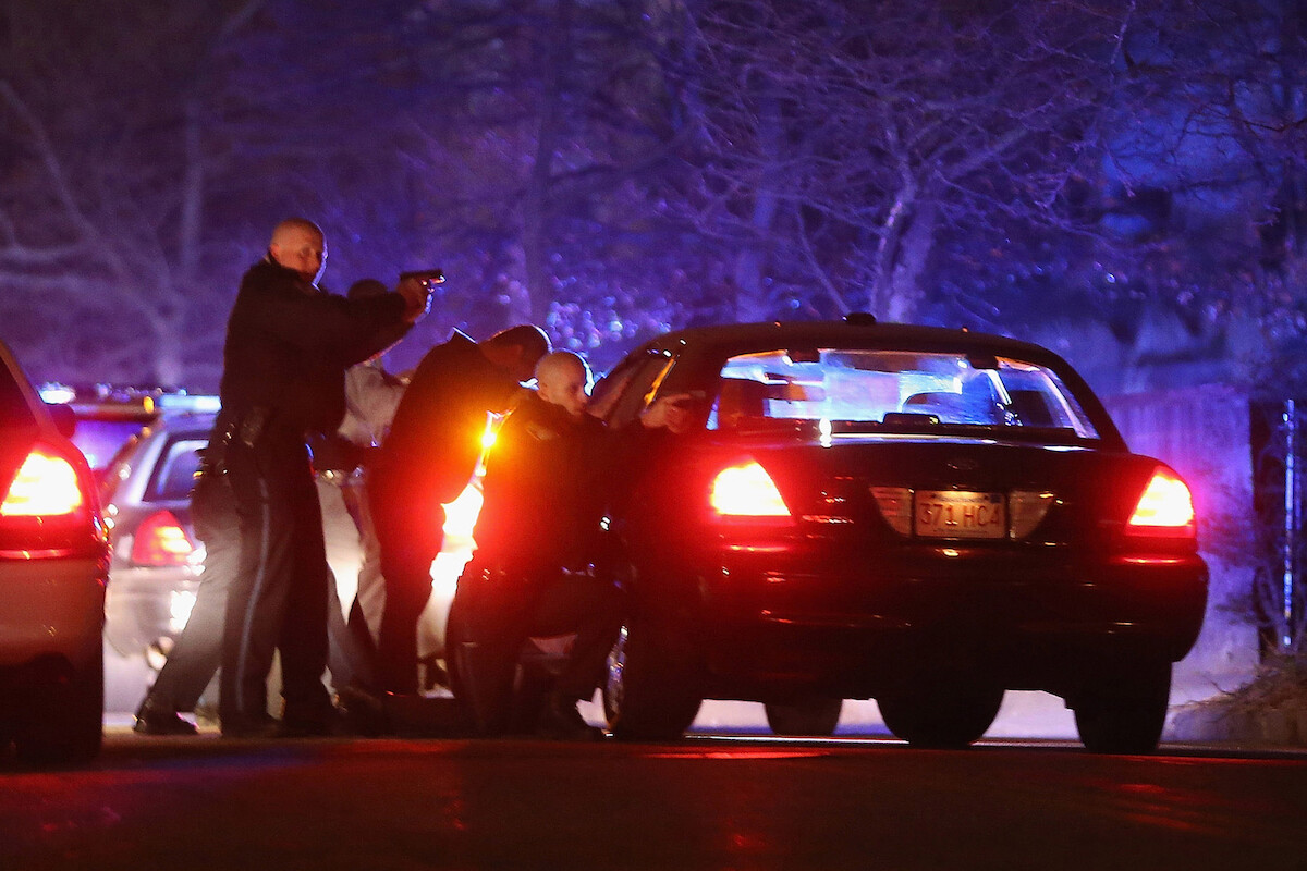 Police with guns drawn.