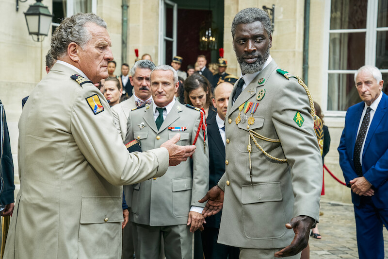 Patrick Rocca as Colonel François de Criqui and Omar Sy as Assane Diop stand together wearing military uniforms in Season 3 of 'Lupin.'