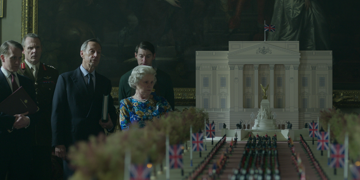 Imelda Staunton as Queen Elizabeth looks a a minature model of a funeral procession in Season 6 Part 2 of ‘The Crown’