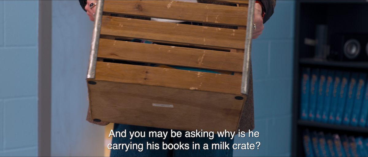 A close up of the milk crate that Dunkleman from Tall Girl holds