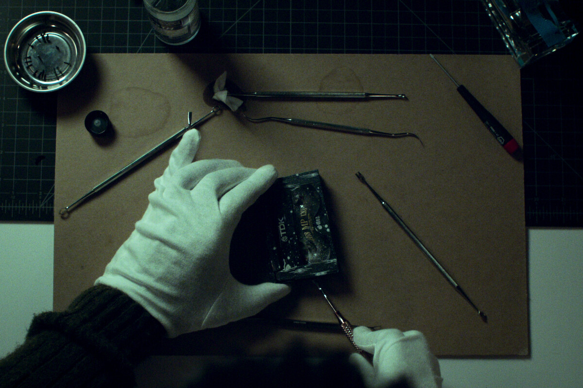 A close up of someone working to restore film