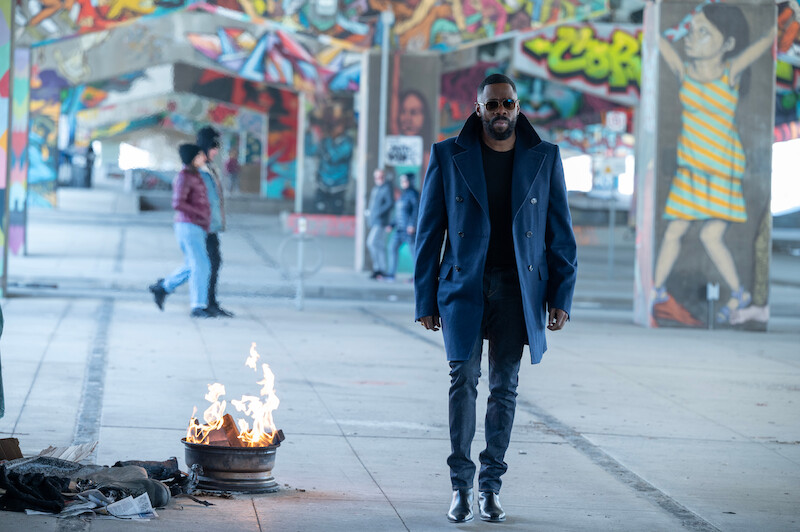 Colman Domingo as Muncie Daniels walks under a bridge with graffiti in Season 1 of ‘The Madness.’